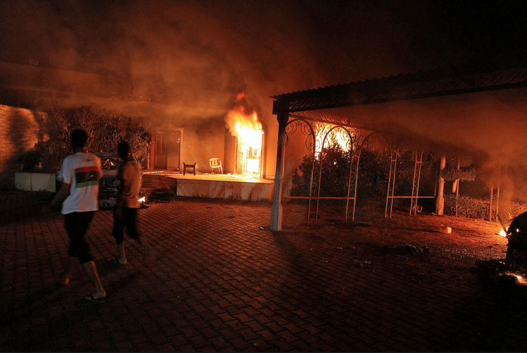 A vehicle R and the surround buildings burn after they were set on fire inside the U.S. consulate compound in Benghazi late on Sept. 11 2012. Getty Images 768x514