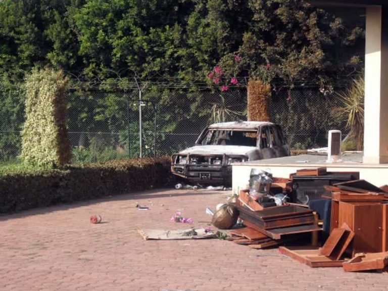Exterior of the QRF villa the morning after the Benghazi attack with pile of materials abandoned by looters. Photo by Morgan Jones 768x576